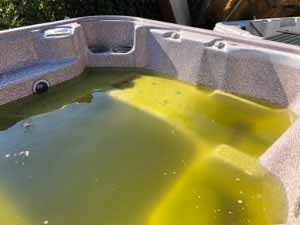 Hot tub filled with cloudy yellow water